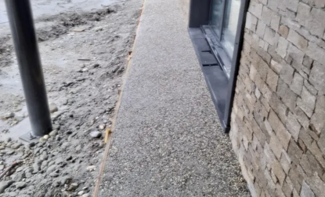 Création trottoir en béton désactivé autour d'un batiment